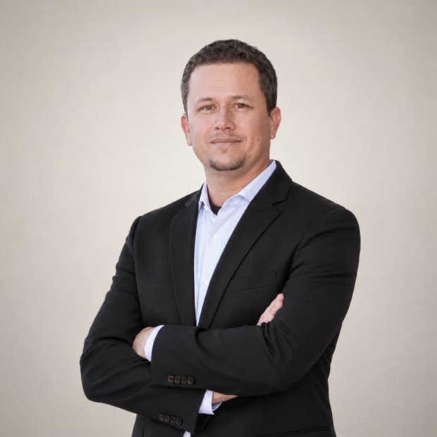 Professional man in black blazer with arms crossed