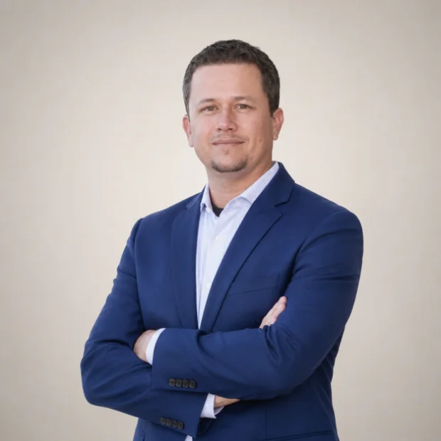 Professional man in blue blazer with arms crossed