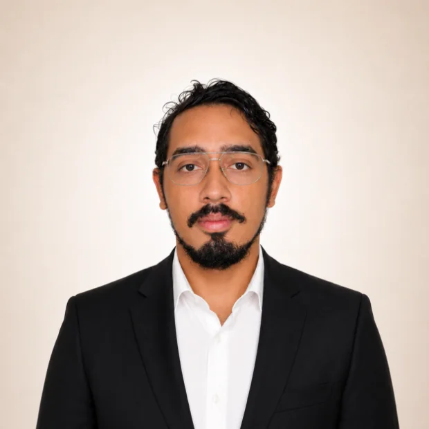 Young professional man in black suit with glasses