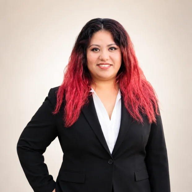 Professional woman with red ombre hair in black blazer