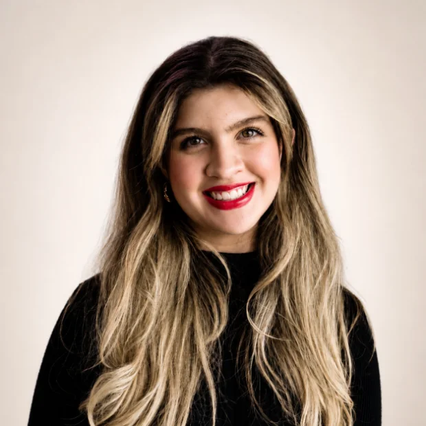 Smiling young woman with long hair and red lipstick